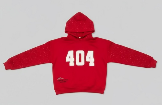 Red hoodie with '404' printed on it laid flat on a wooden floor.